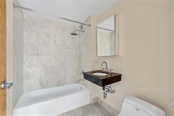 a bathroom with a sink a bathtub and a shower