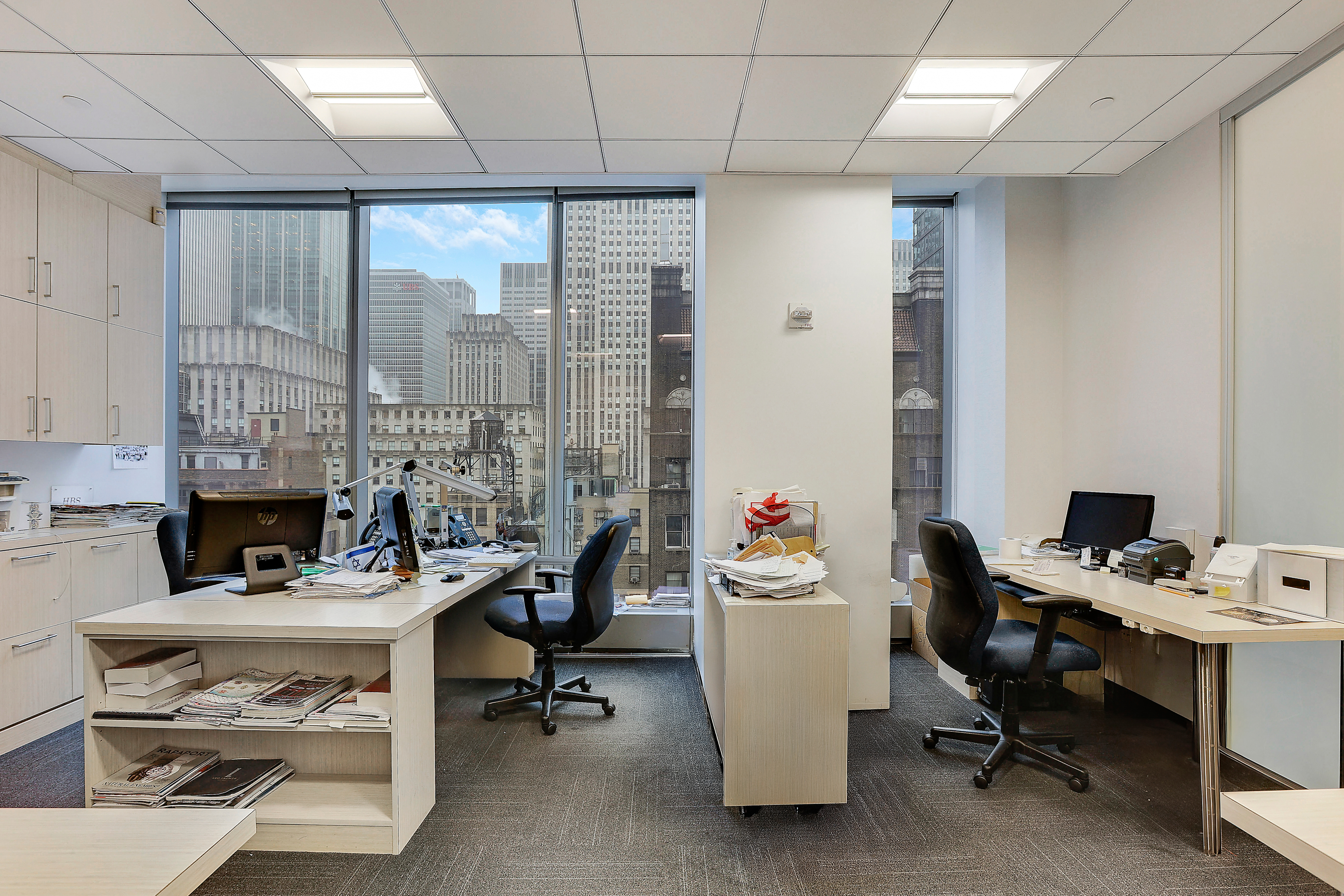 50 West 47th Street Manhattan, NY 10036 - Photo 4 of 8 a view of a workspace with furniture and a livingroom