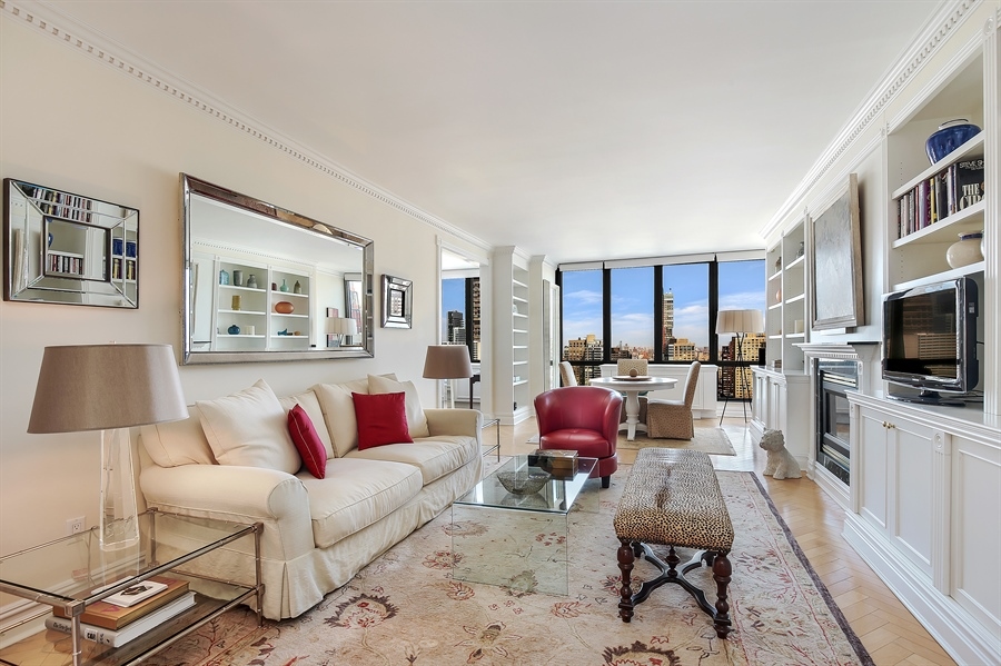 2 Columbus Avenue, Unit 32A Manhattan, NY 10023 - Photo 2 of 12 a living room with furniture or couch and a flat screen tv