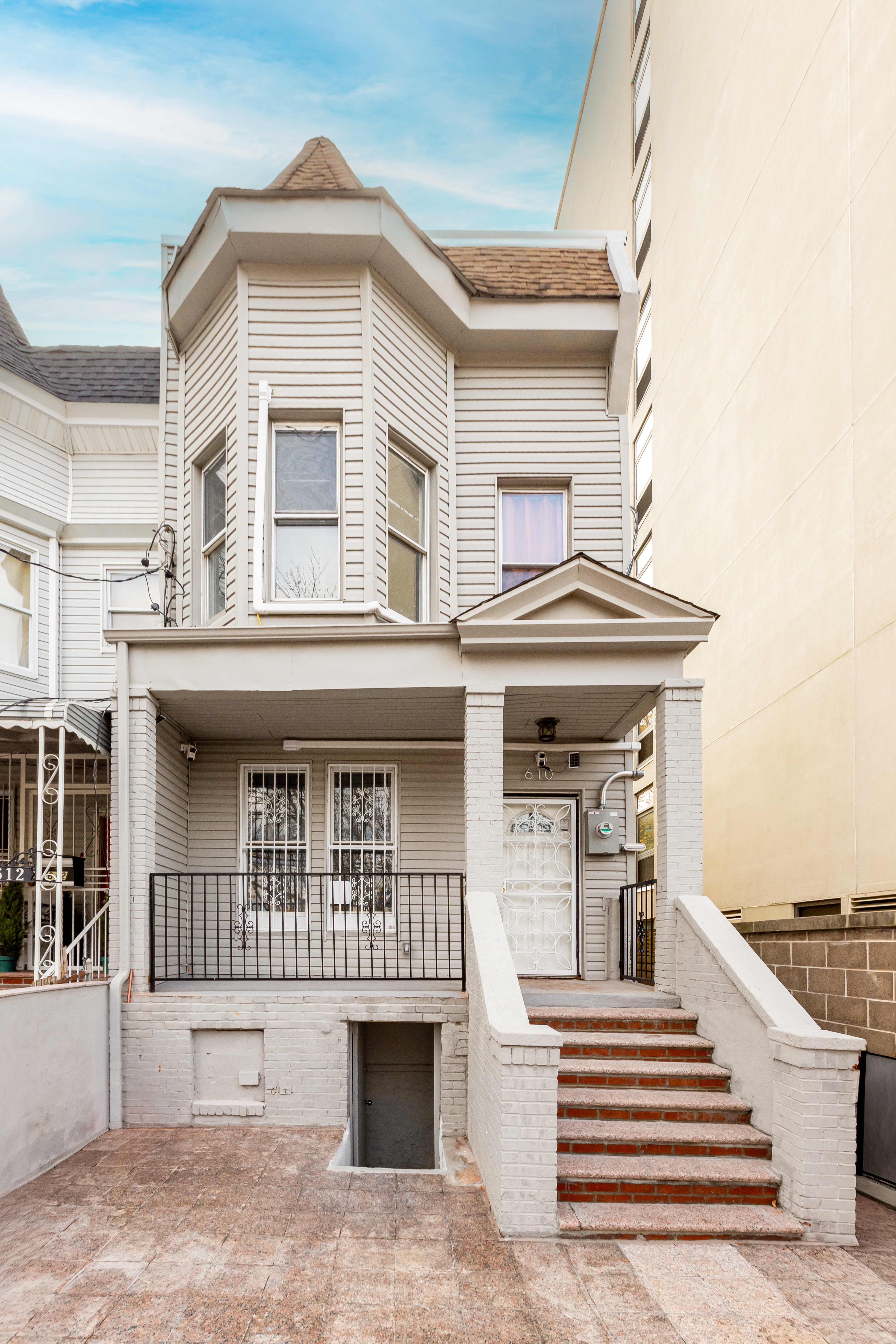 610 East 181st Street Bronx, NY 10457 - Photo 12 of 13 a view of a house with large windows and stairs