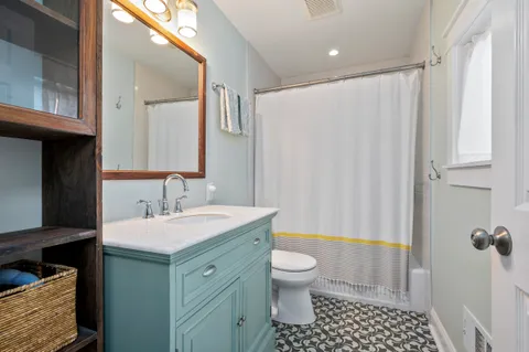 a bathroom with a sink a toilet and a mirror