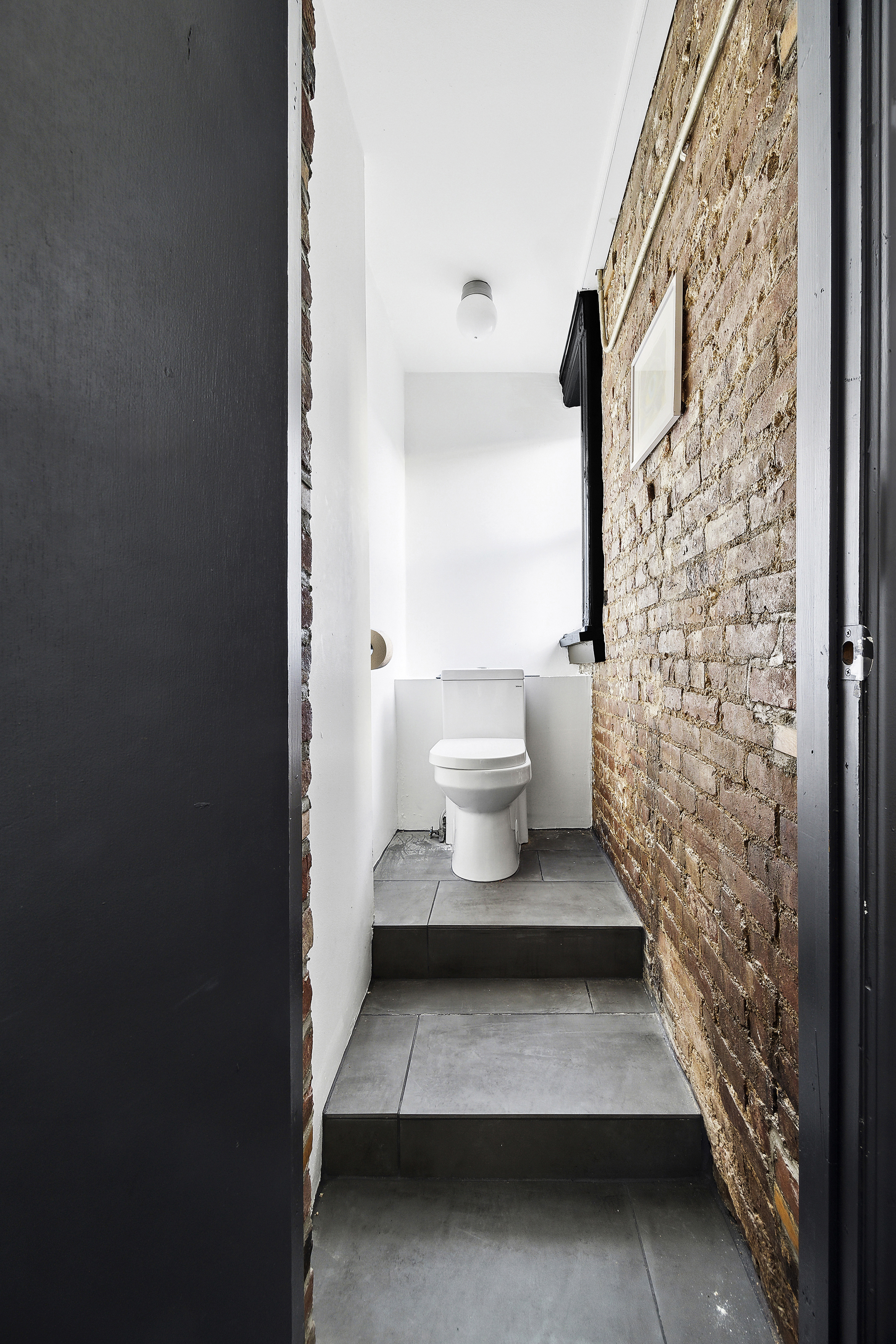 633 East 11th Street, Unit 23 Manhattan, NY 10009 - Photo 6 of 8 a bathroom with a toilet and a shower curtain
