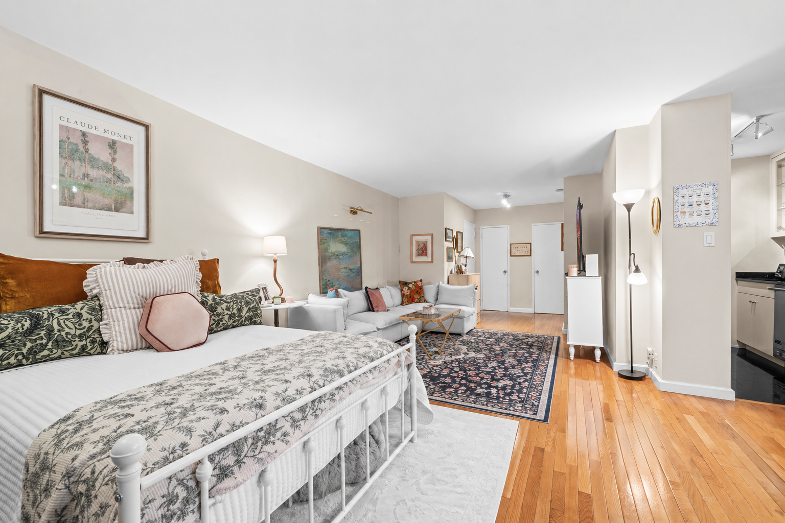 1175 York Avenue, Unit 1K Manhattan, NY 10065 - Photo 2 of 10 a bedroom with a large bed and a chandelier