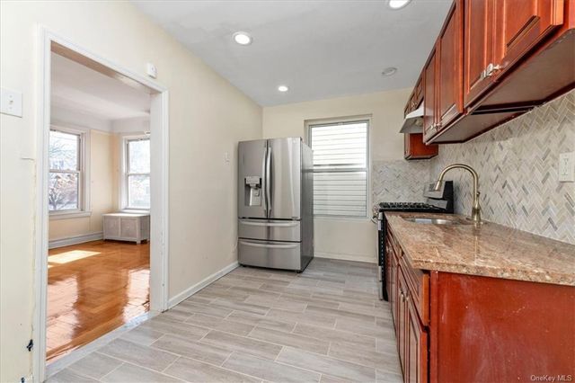1186 Brooklyn Avenue, Unit N A Brooklyn, NY 11203 - Photo 14 of 17 a kitchen with stainless steel appliances granite countertop a sink and a refrigerator