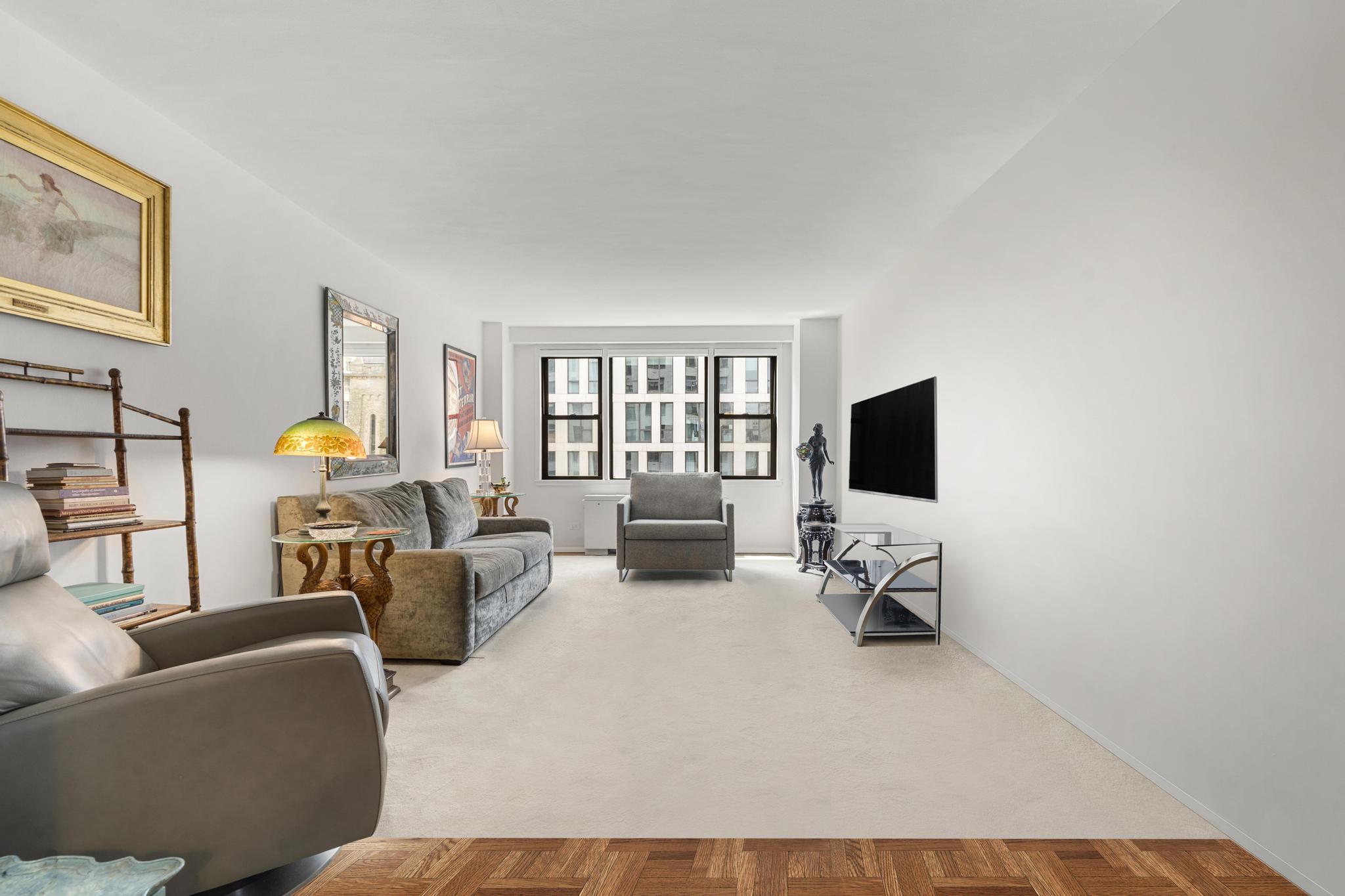 201 East 21st Street, Unit 8E Manhattan, NY 10010 - Photo 3 of 9 a living room with furniture and a flat screen tv with wooden floor