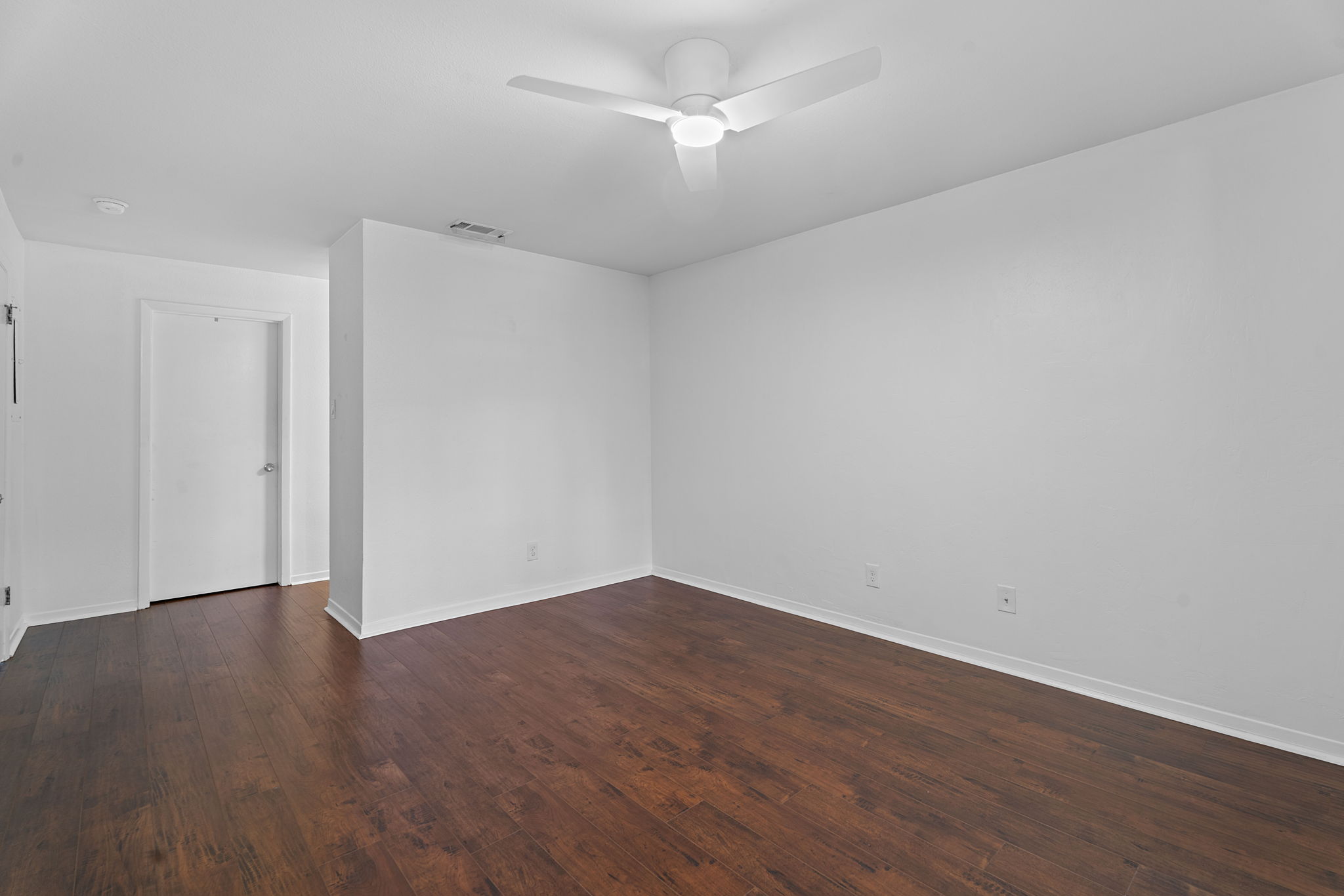 1510 West N Loop Boulevard, Unit 424 Austin, TX 78756 - Photo 16 of 25 an empty room with wooden floor and fan