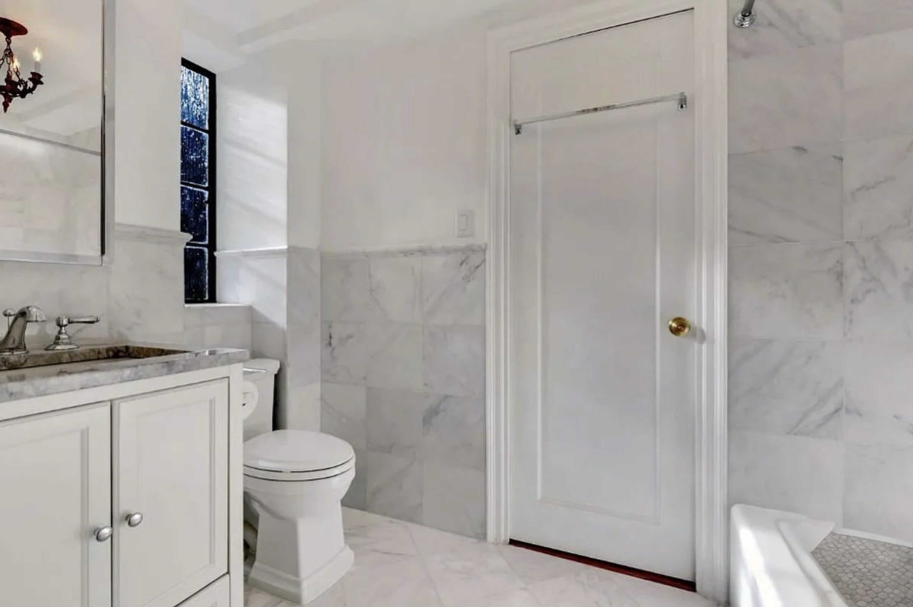 230 East 50th Street, Unit 3B Manhattan, NY 10022 - Photo 15 of 21 a bathroom with a granite countertop sink toilet and shower