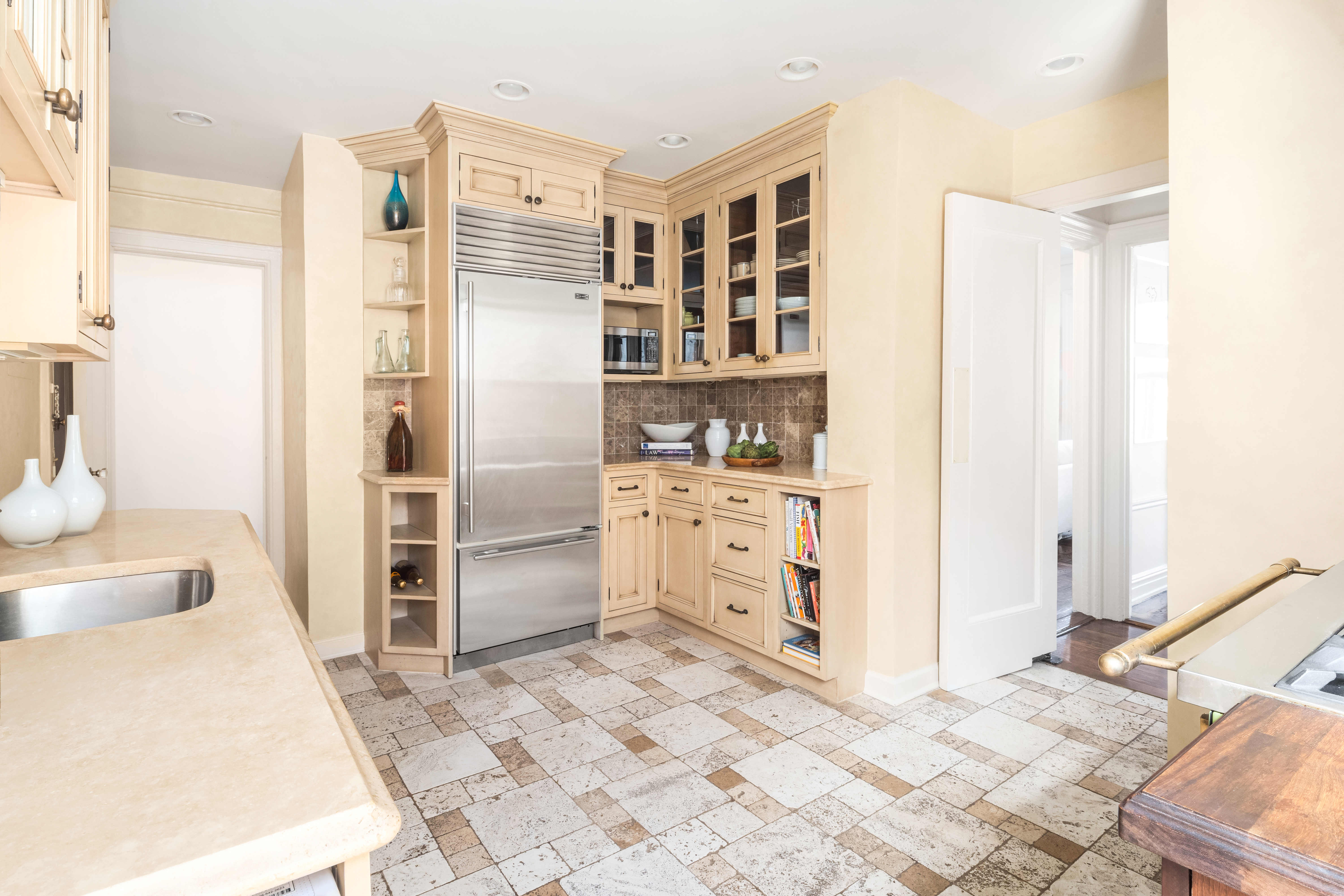 41 West 82nd Street, Unit 9D Manhattan, NY 10024 - Photo 6 of 15 a kitchen with stainless steel appliances a refrigerator and cabinets