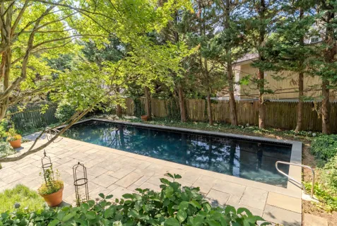 a view of swimming pool with a patio