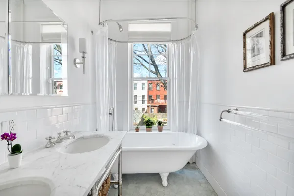 a bath room with a sink and a mirror