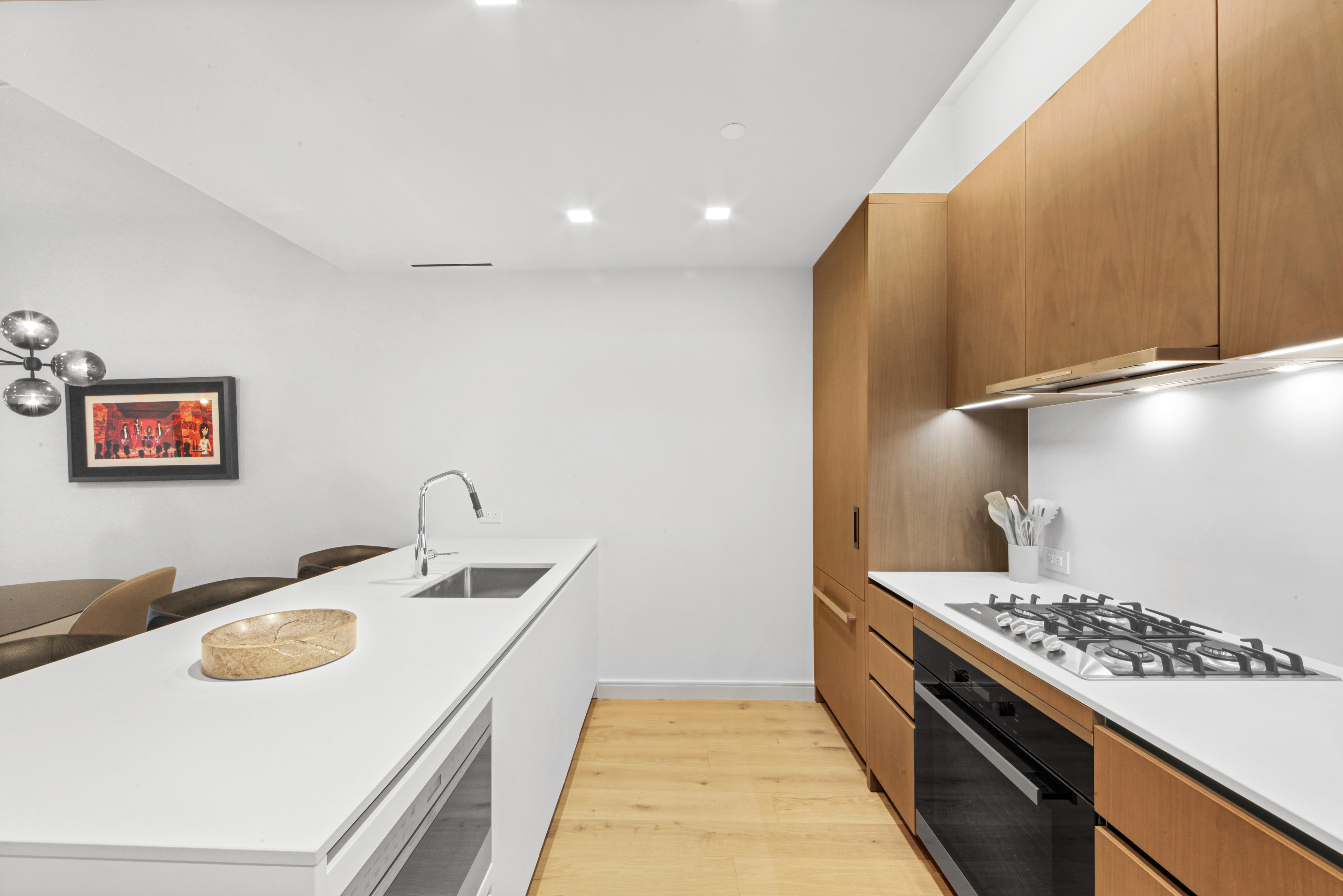 200 East 21st Street, Unit 4B Manhattan, NY 10010 - Photo 7 of 15 a kitchen with a sink and a stove top oven