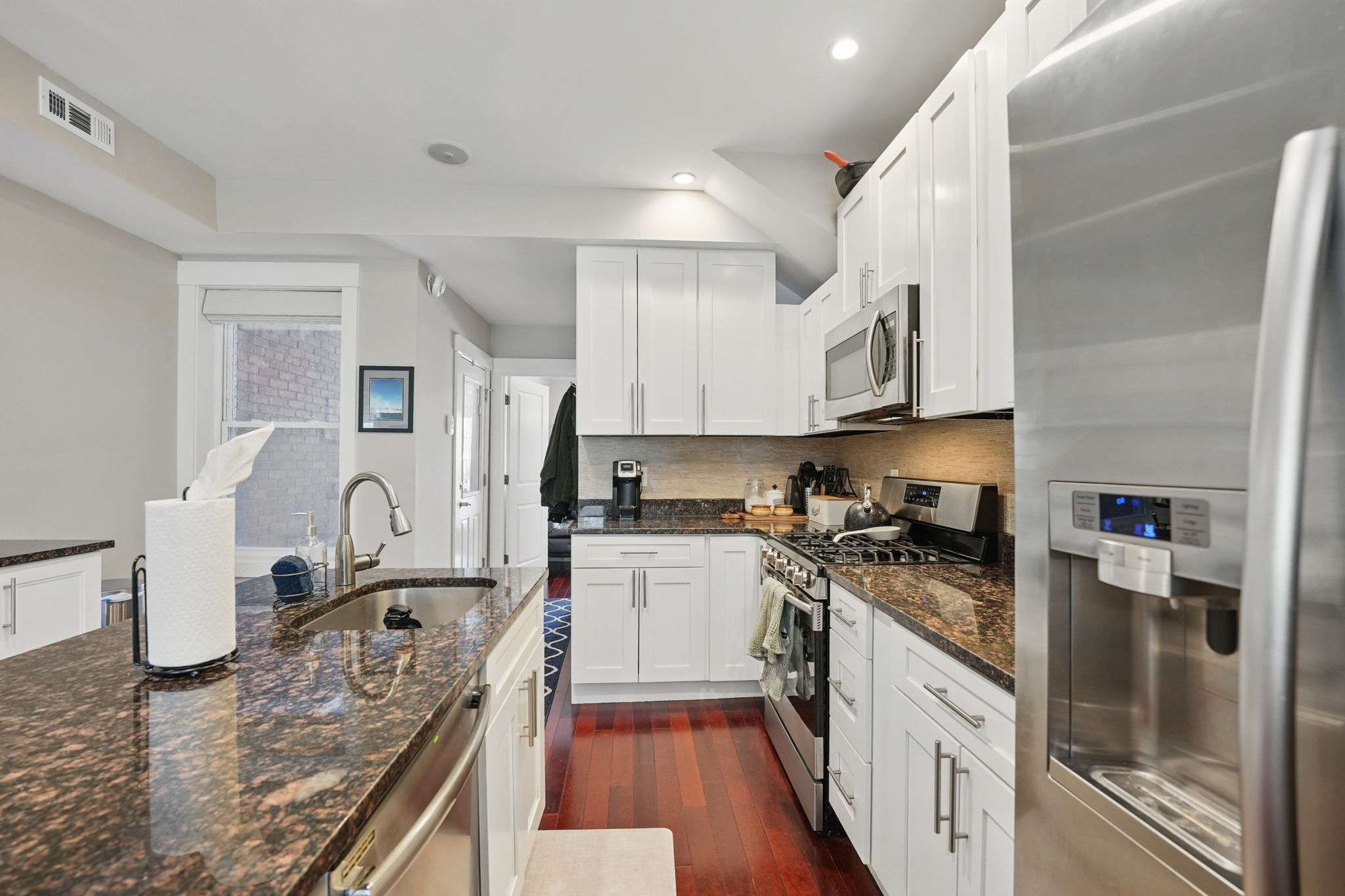 28 Q Street Northeast, Unit 2 Washington, DC 20002 - Photo 10 of 41 a kitchen with granite countertop a sink a stove and refrigerator