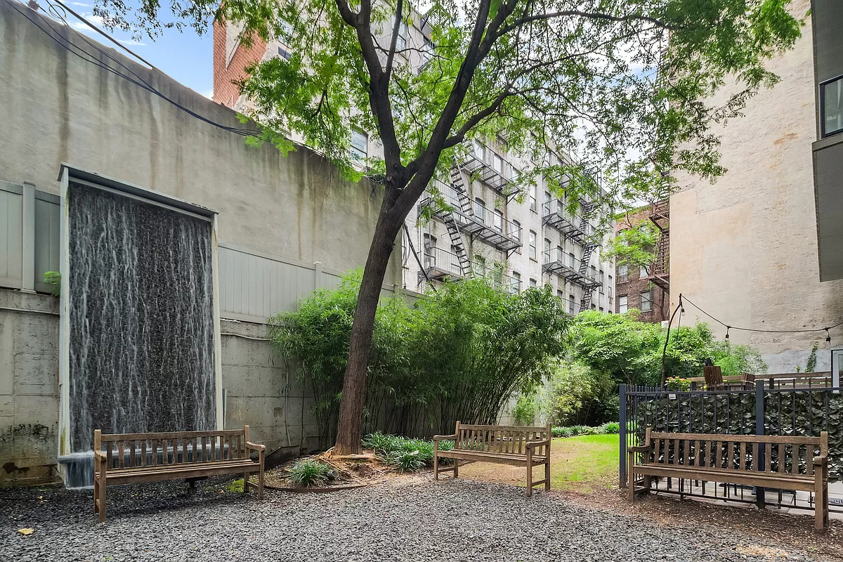 350 West 53rd Street, Unit THG Manhattan, NY 10019 - Photo 23 of 25 a backyard of a house with barbeque oven and trees