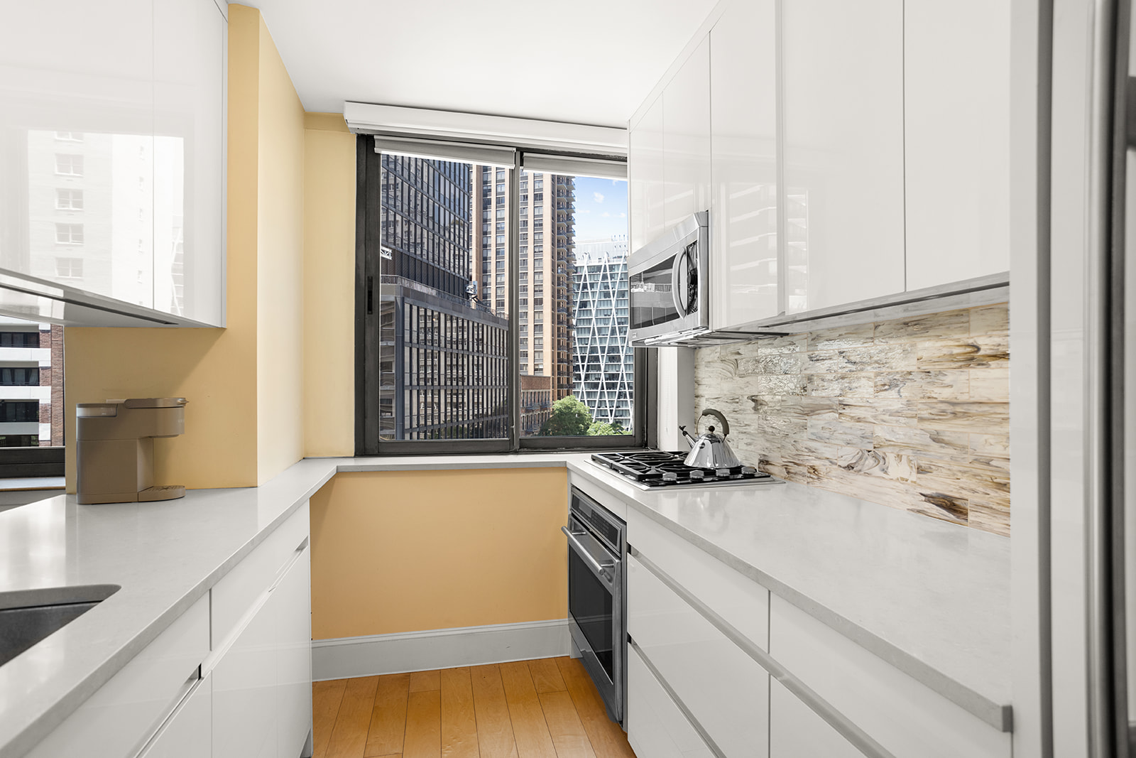 2000 Broadway, Unit 5I Manhattan, NY 10023 - Photo 3 of 9 a view of a kitchen with a sink and wooden floor