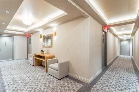 a hallway with furniture and a rug