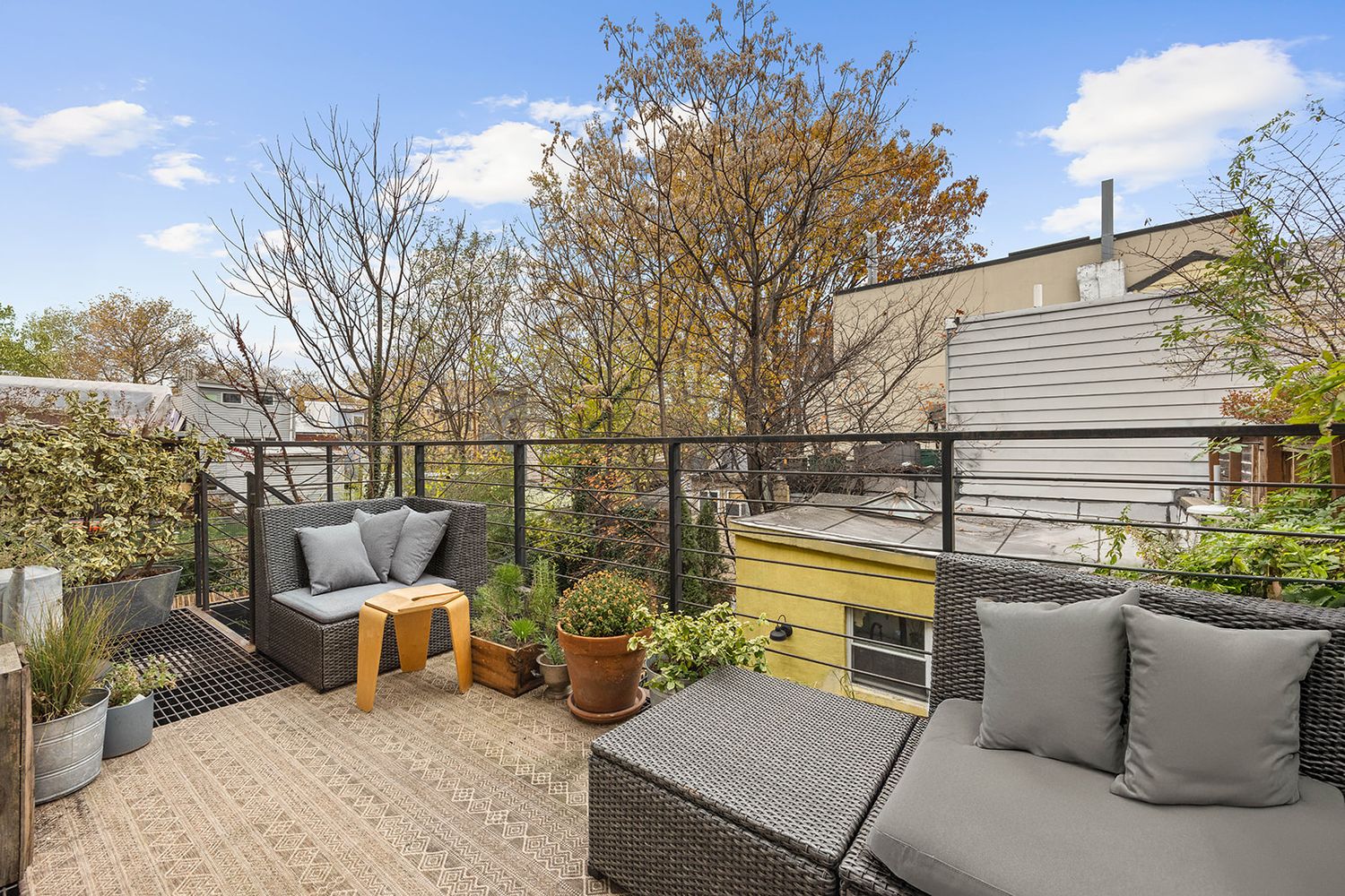 a view of a patio with couches chairs and a fire pit