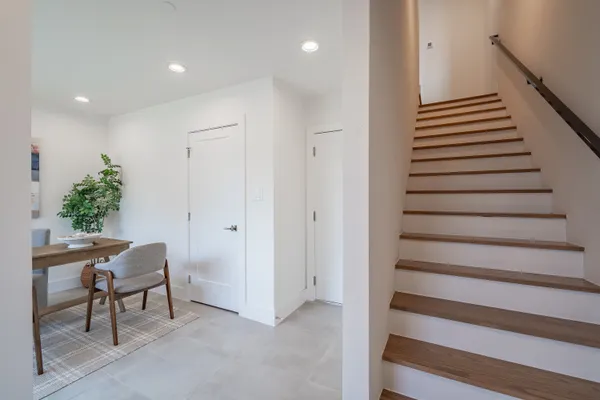 a kitchen with kitchen island stainless steel appliances a refrigerator a sink a stove a microwave and wooden floor
