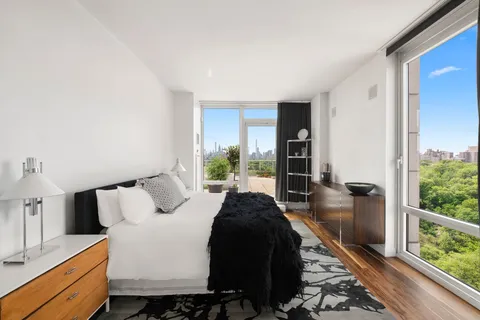 a bed room with a bed and a large window