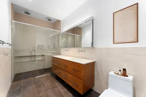 a bathroom with a sink a toilet and a mirror