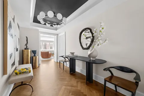 a view of a livingroom with furniture and a mirror