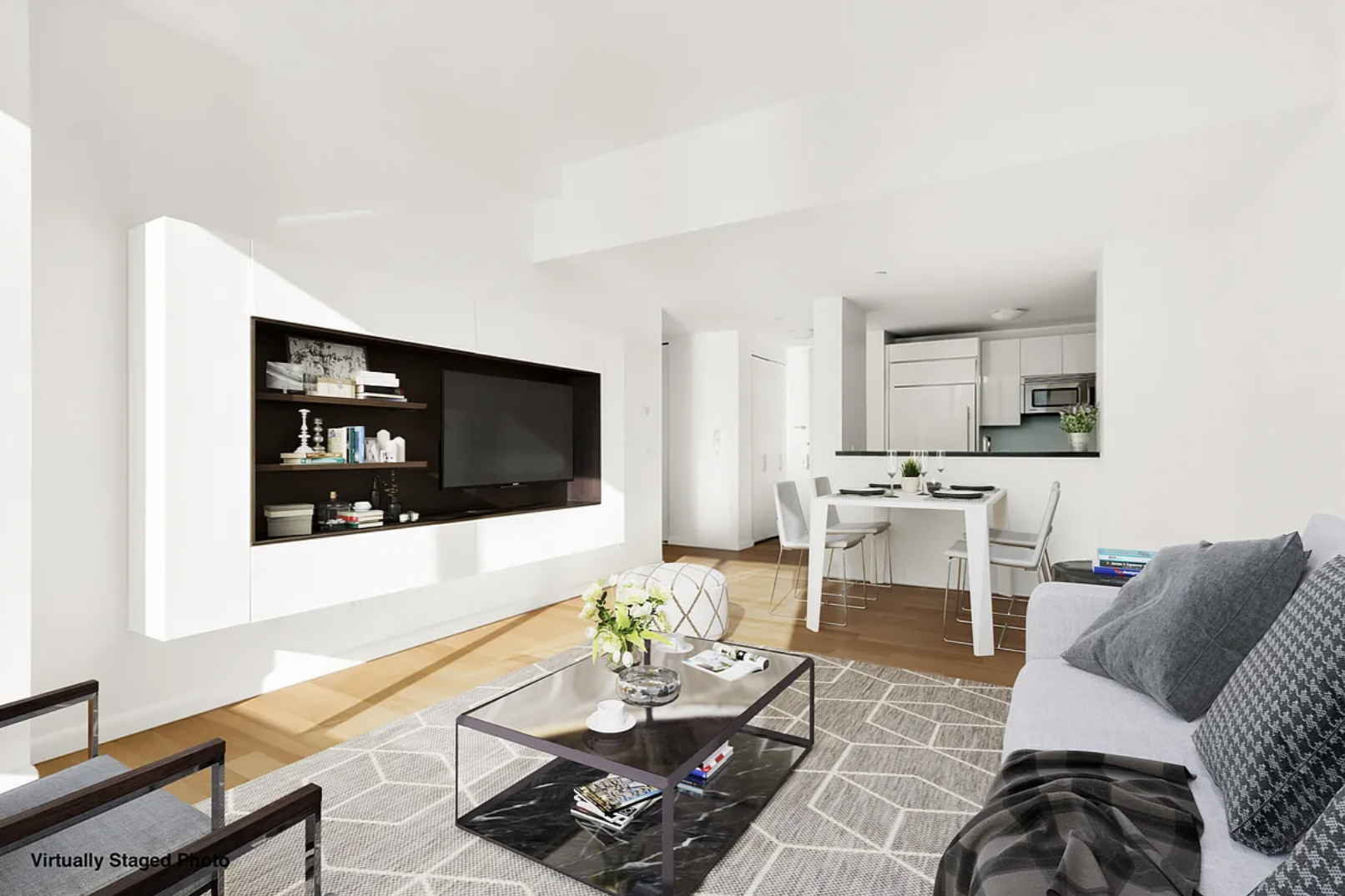 46-30 Center Boulevard, Unit 1209 Queens, NY 11109 - Photo 2 of 26 a living room with furniture a flat screen tv and kitchen view