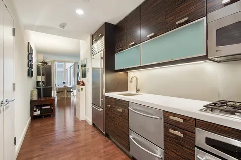 a kitchen with a sink cabinets and stainless steel appliances