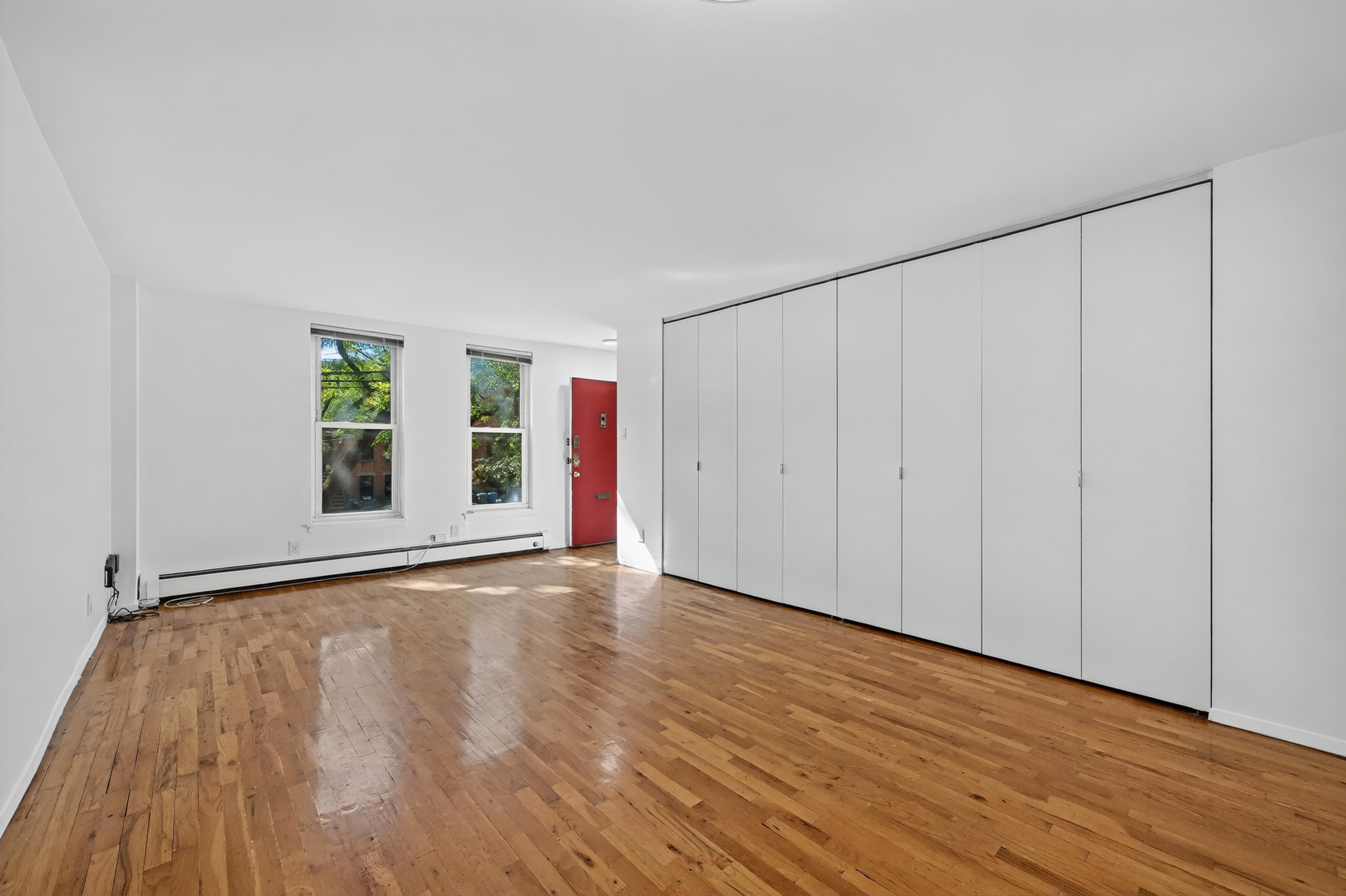 81 President Street, Unit 51-A Brooklyn, NY 11231 - Photo 7 of 27 a view of an empty room with wooden floor and a window