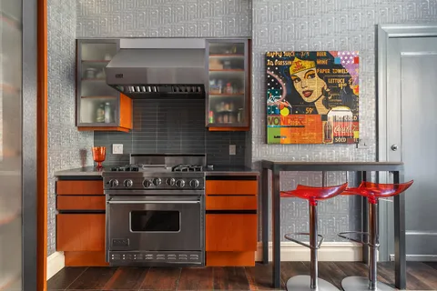 a kitchen with stainless steel appliances granite countertop a stove and cabinets