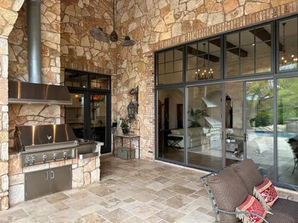 a bathroom with a granite countertop sink a mirror and shower