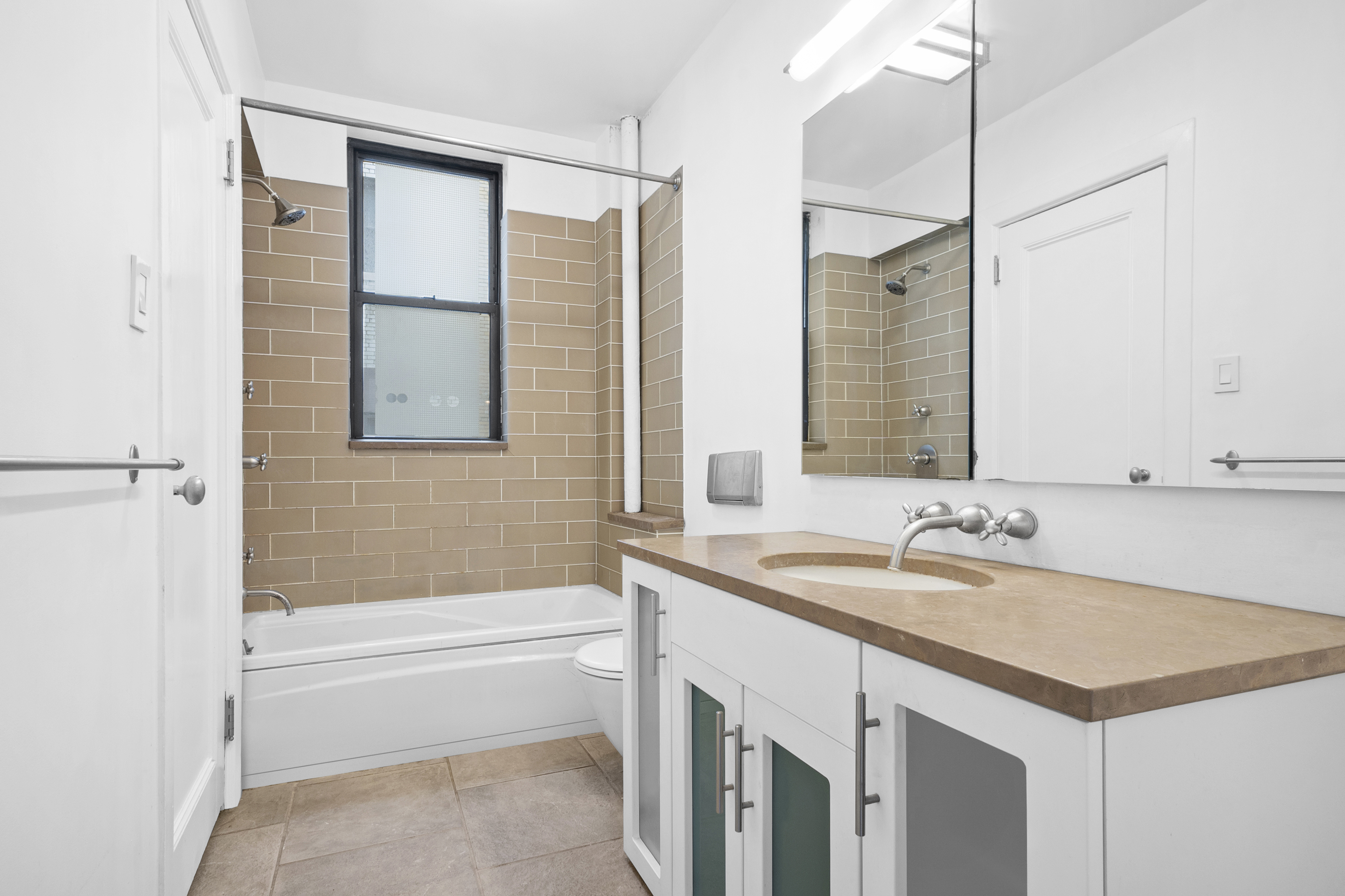 146 East 49th Street, Unit 6CD Manhattan, NY 10017 - Photo 11 of 12 a bathroom with a sink and a bathtub
