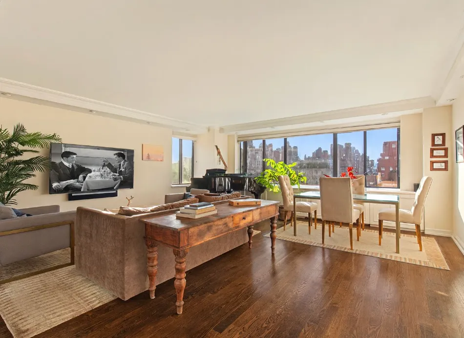 a dining room with furniture a window and wooden floor