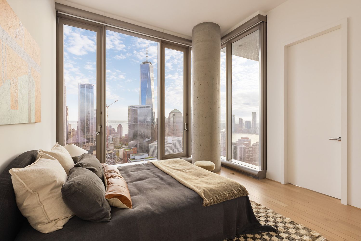 a bedroom with bed and a large window