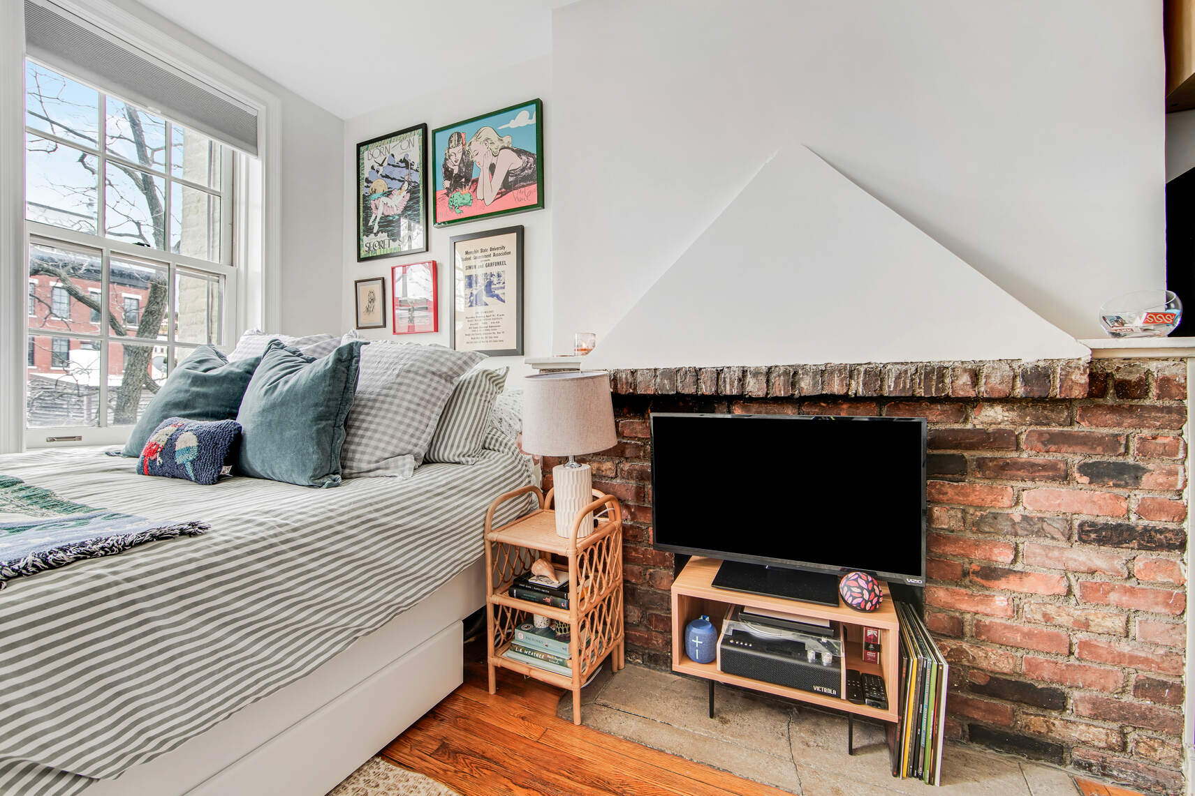 352 West 12th Street, Unit 5D Manhattan, NY 10014 - Photo 4 of 11 a bedroom with a bed and a flat screen tv