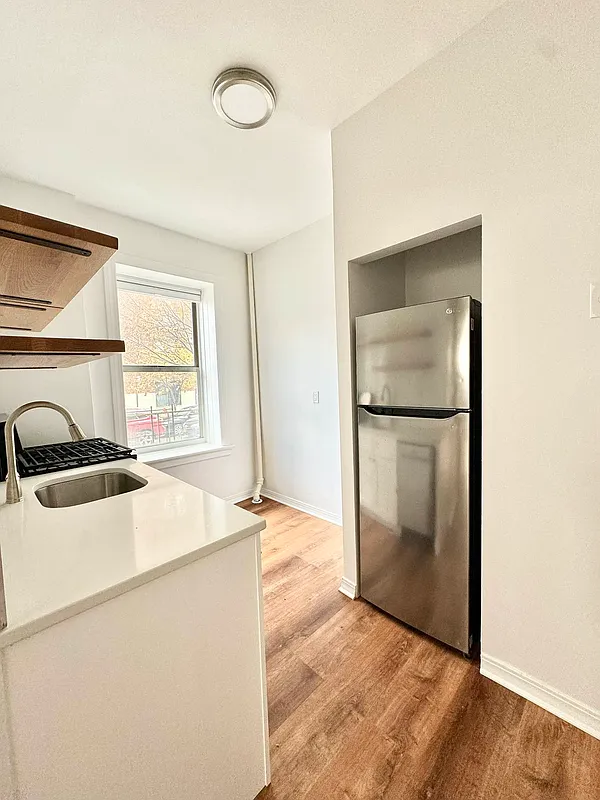 2022 Beverley Road, Unit 3 Brooklyn, NY 11226 - Photo 3 of 11 a kitchen with a refrigerator and a sink