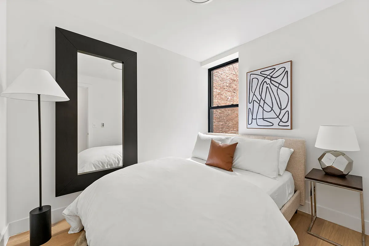 168 Sumpter Street, Unit 2 Brooklyn, NY 11233 - Photo 5 of 10 a bedroom with a bed and a lamp on table