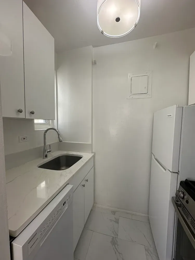 a kitchen with a sink and refrigerator