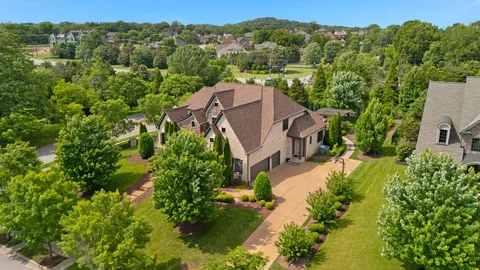 an aerial view of a house with garden space and street view