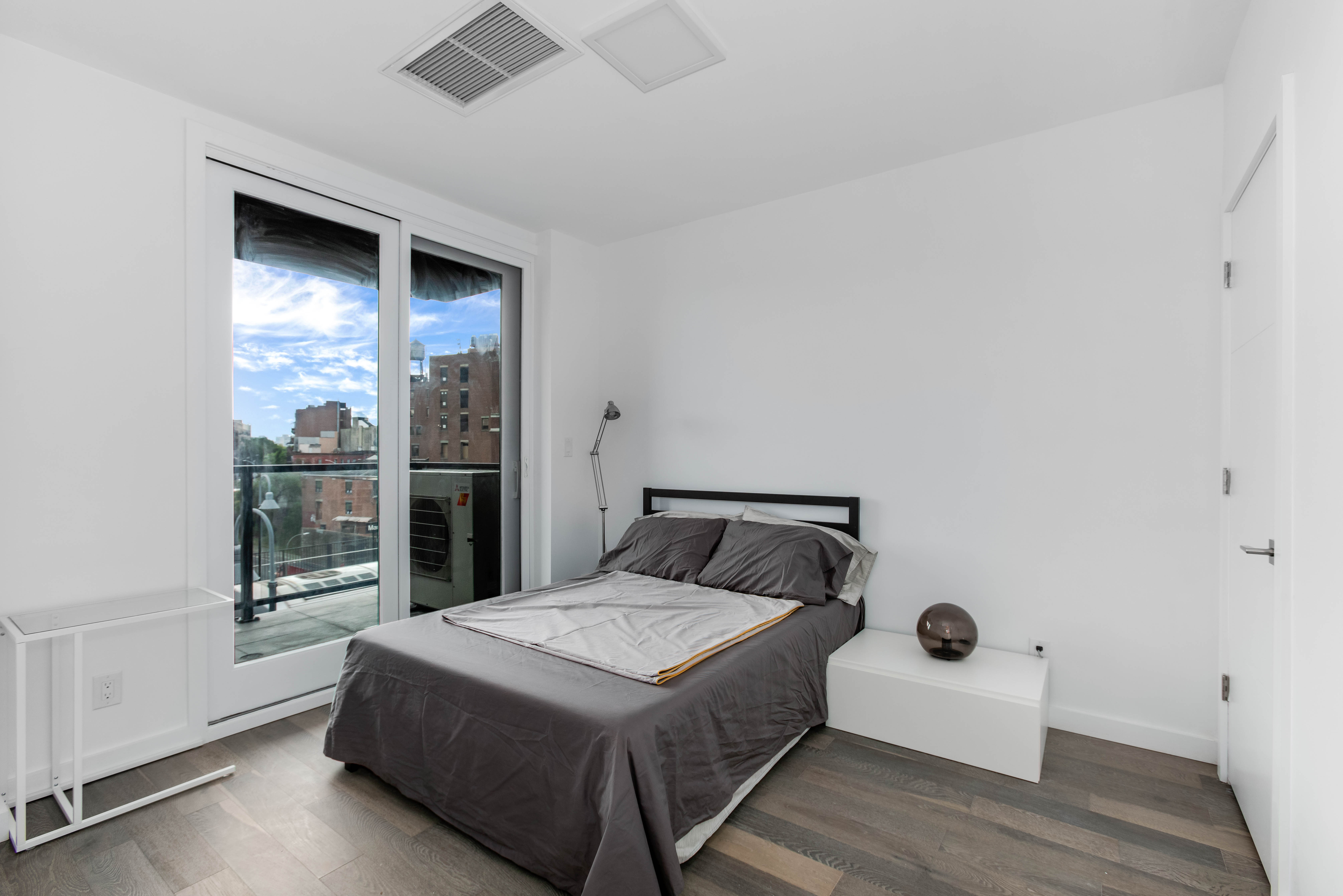 319 Broadway, Unit 6B Brooklyn, NY 11211 - Photo 3 of 5 a bedroom with a bed and a large window