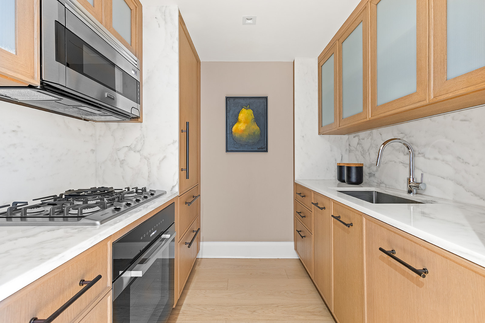 210 Warren Street, Unit 10G Manhattan, NY 10282 - Photo 4 of 15 a kitchen with stainless steel appliances granite countertop a stove and a sink