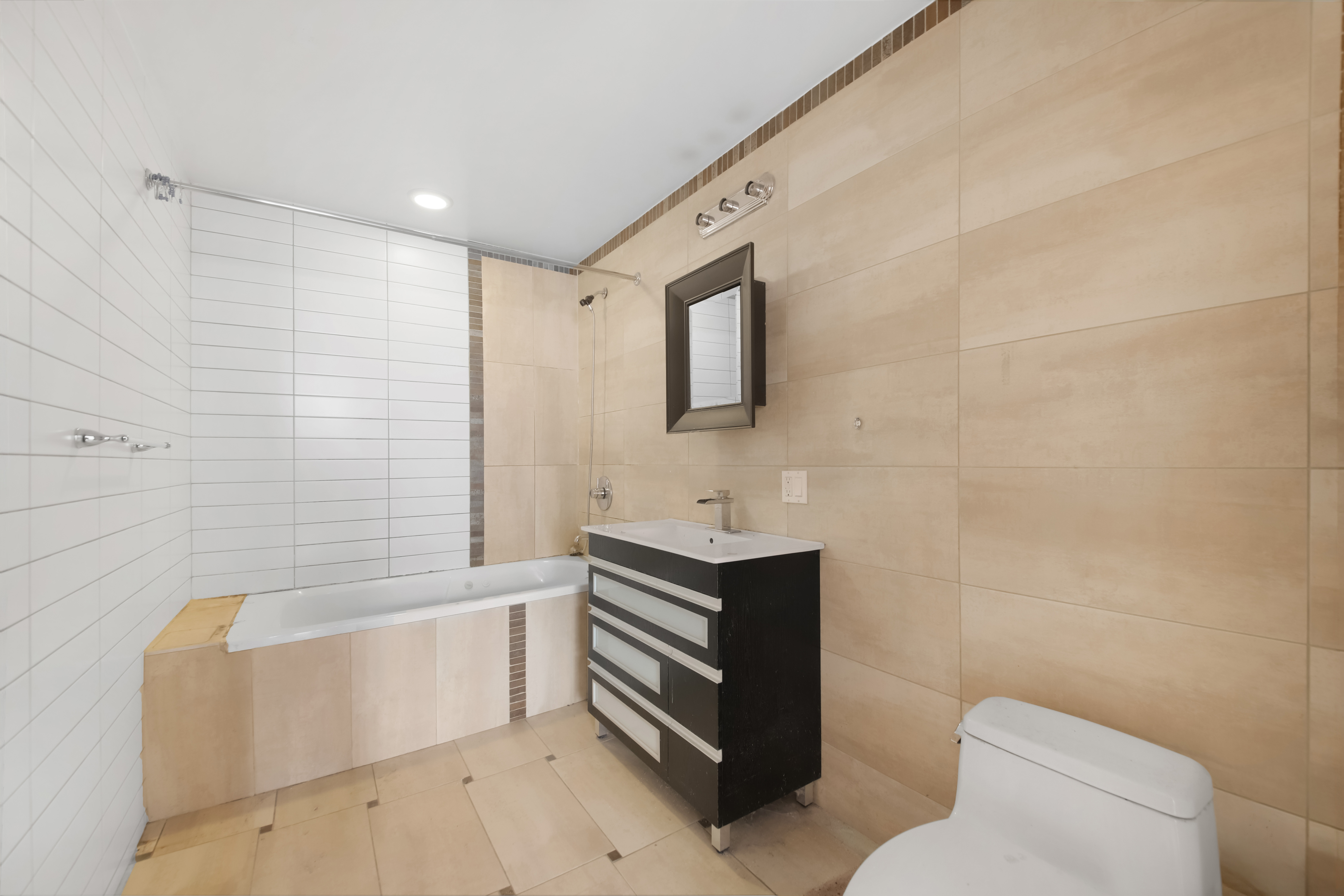 3112 Emmons Avenue, Unit 107 Brooklyn, NY 11235 - Photo 8 of 14 a bathroom with a sink a toilet and bathtub