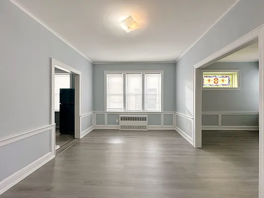 364 97th Street, Unit 2 Brooklyn, NY 11209 - Photo 6 of 8 wooden floor in an empty room with a window