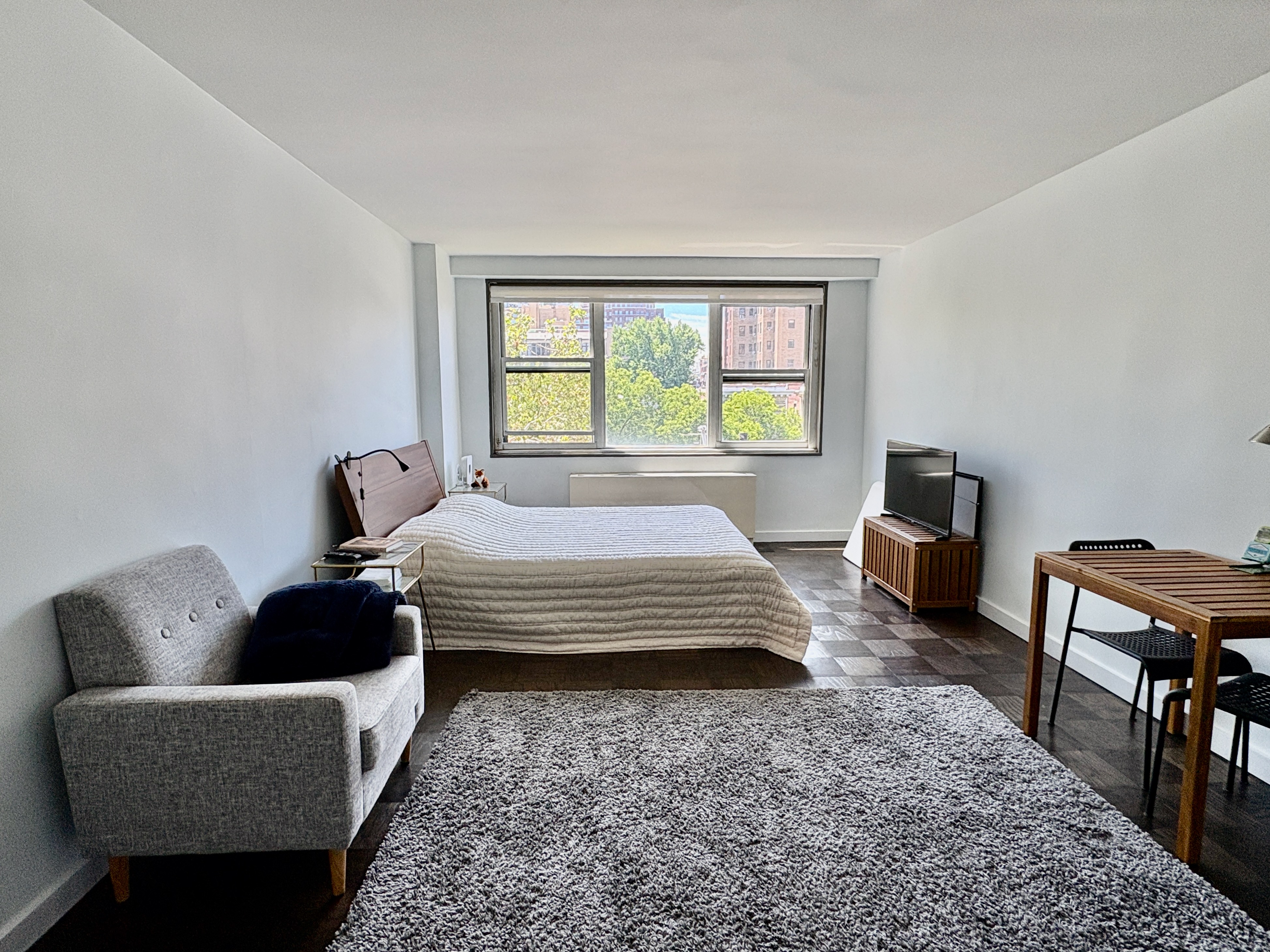 360 West 22nd Street, Unit 7P Manhattan, NY 10011 - Photo 1 of 13 a bedroom with a bed a couch and a window