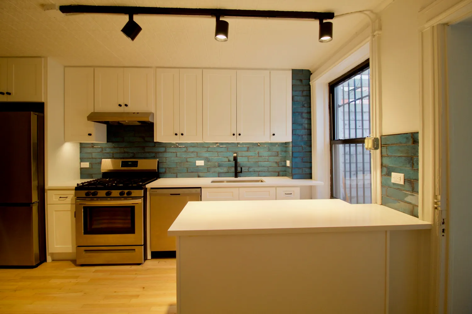 a spacious bedroom with a large window and a bed