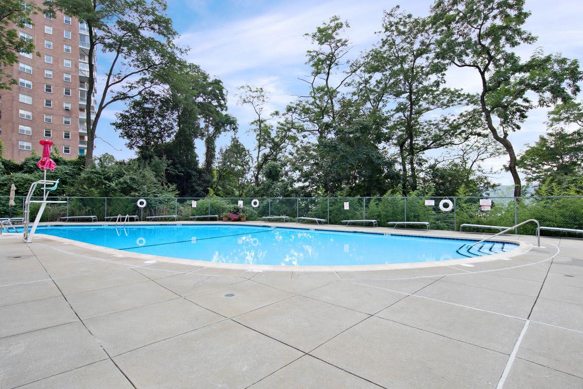 2727 Palisade Avenue, Unit 3H Bronx, NY 10463 - Photo 12 of 18 a view of swimming pool with trees in the background
