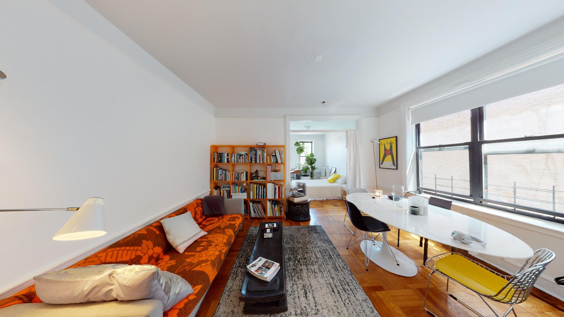 a living room with furniture fireplace and a large window
