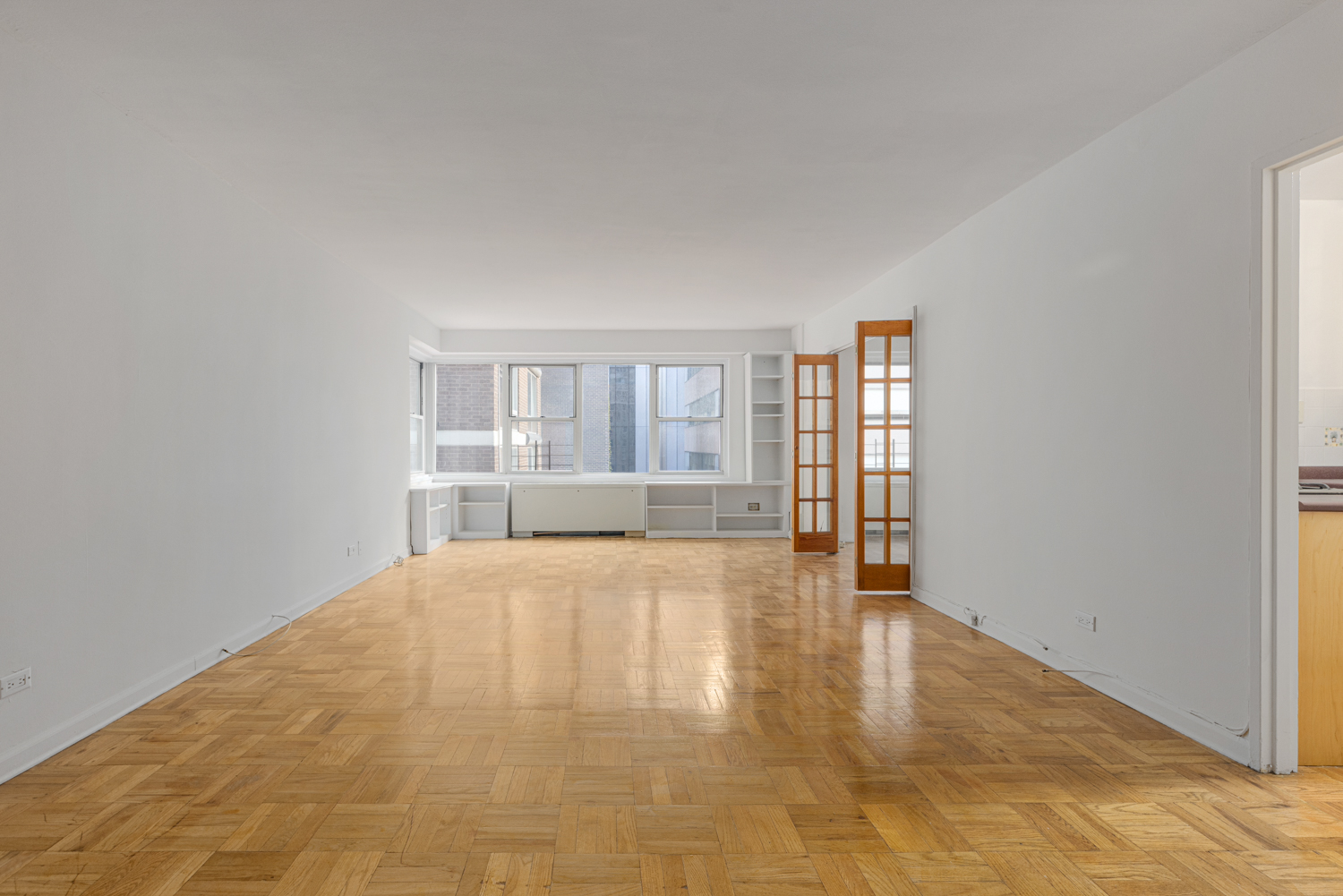 136 East 56th Street, Unit 9J Manhattan, NY 10022 - Photo 5 of 14 a view of an empty room with a window