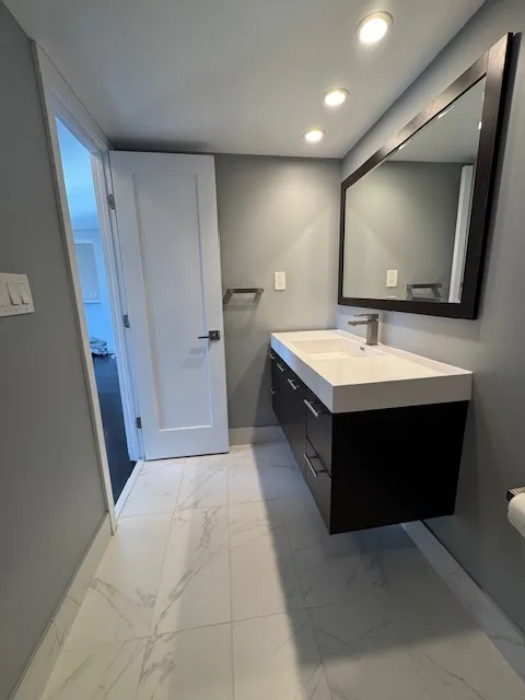 a bathroom with a double vanity sink and mirror