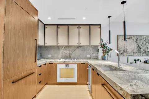 a kitchen with a sink and a refrigerator