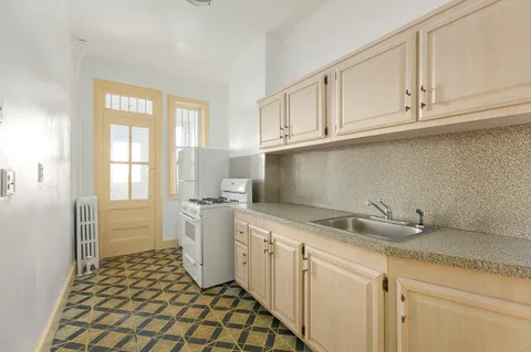 a kitchen with a sink and cabinets