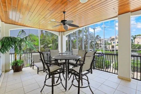 a view of a hallway with wooden floor and furniture